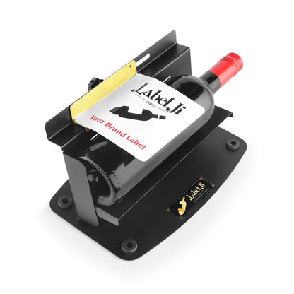 Labelji manual label applicator applying a label on a round wine bottle - black stainless steel design